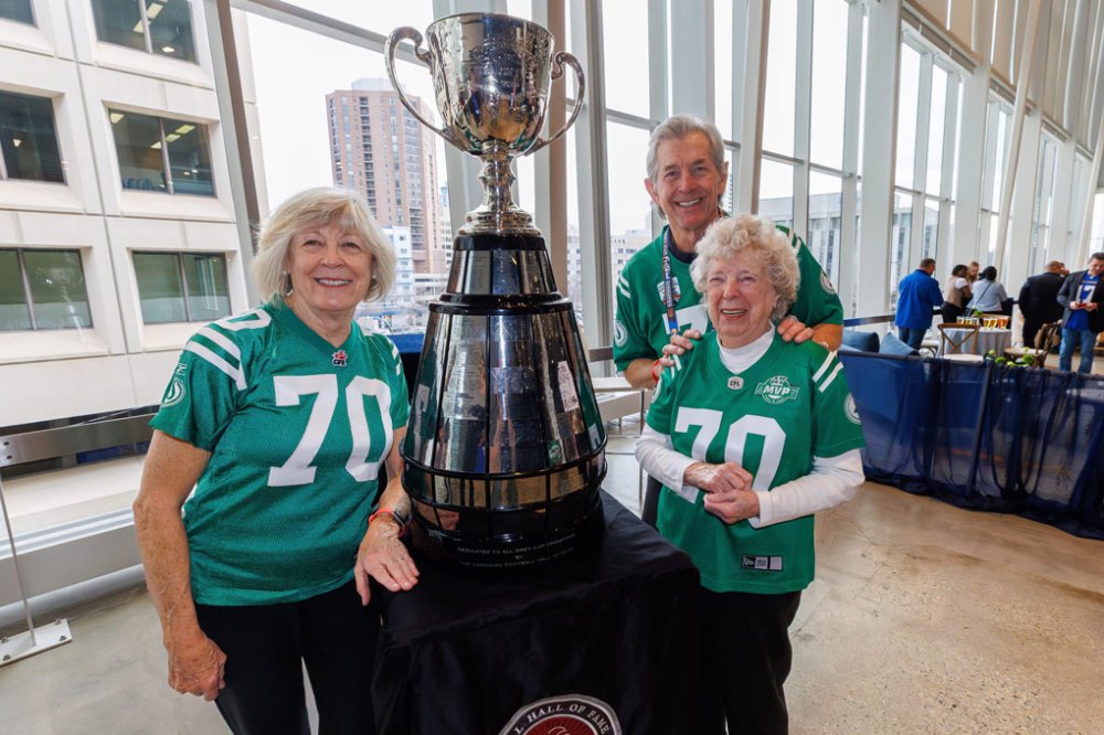 Former Saskatchewan Roughriders wide receiver, Steve Mazurak, with his wife Heather (left) and his 96-year-old mother-in-law, Brenda Thomson and the Grey Cup at the CFLAA Legends Luncheon Friday. (Mike Deal / Free Press)