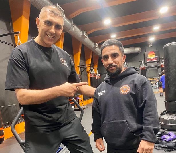 Faisal with his trainer former IBO champion Jawaid Khaliq in his gym