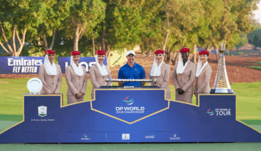 Rory McIlroy stands behind the DP World Tour Championship and the Race To Dubai trophies with six Fly Emirates flight attendants alongside him in 2024