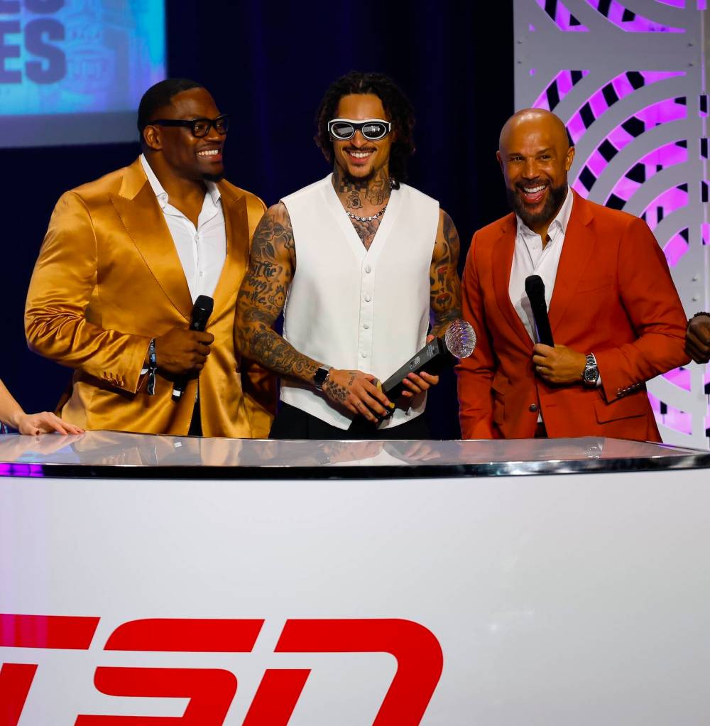 John Woods / THE CANADIAN PRESS
Trey Vaval (centre) celebrates with television hosts Henoc Muamba (left) and Davis Sanchez on Thursday after being named the CFL’s Most Outstanding Special Teams Player.