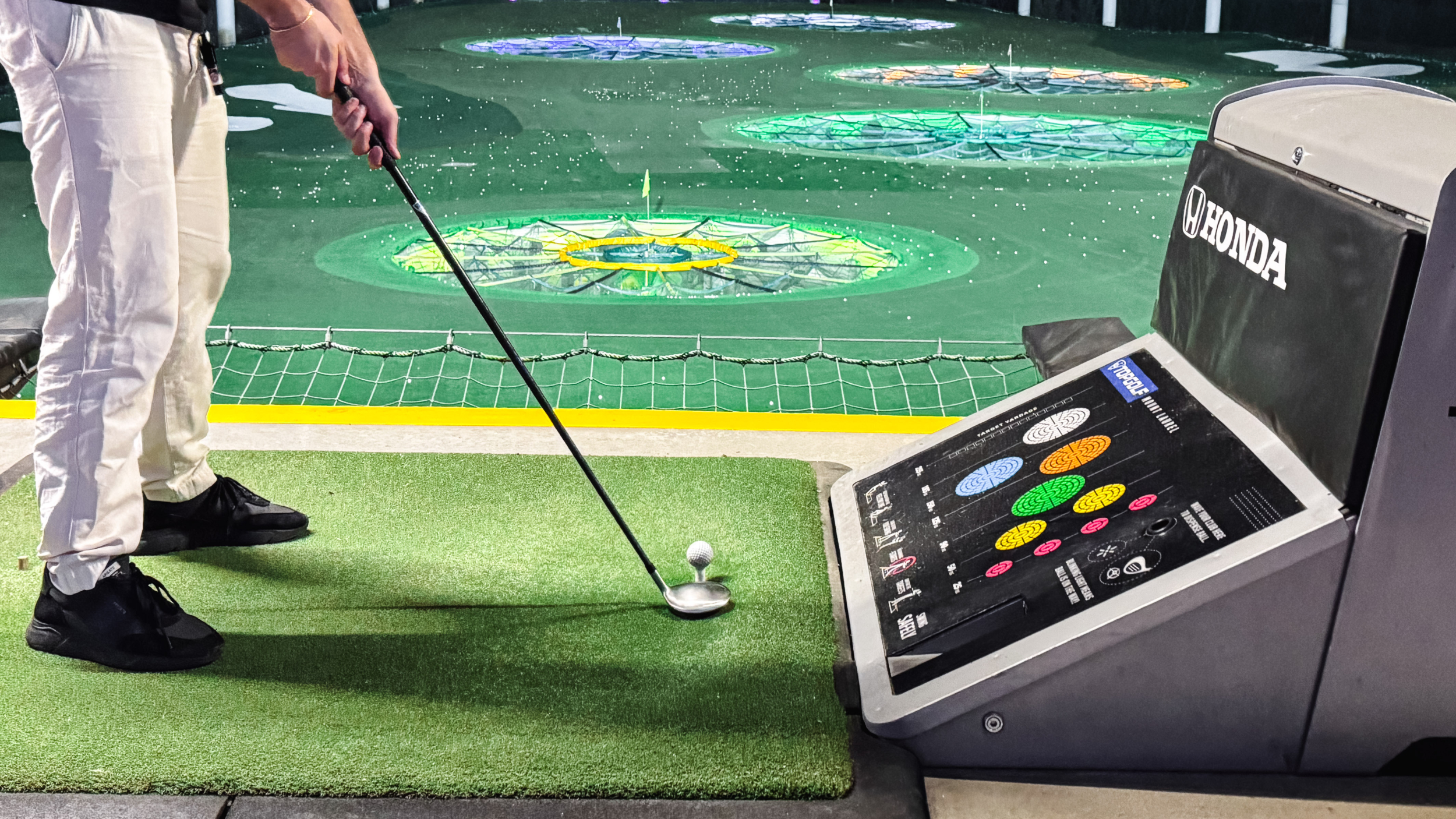 A player lining up a shot at Topgolf