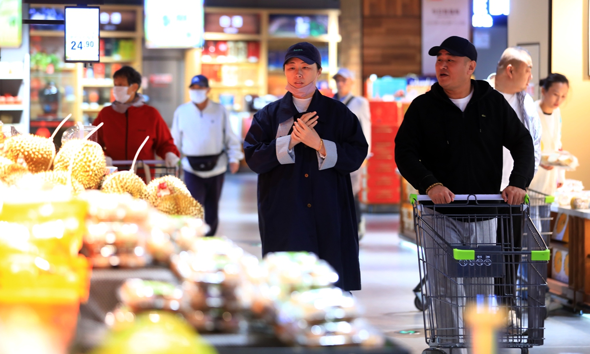 Consumers shop at a supermarket in Huaian, East China