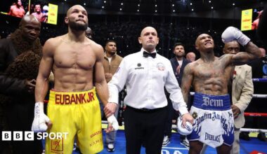 Conor Benn with his arms around his family smiles and poses for a picture after beating Chris Eubank Jr