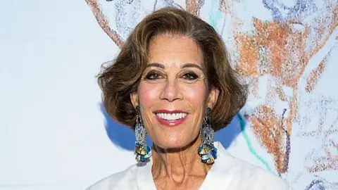 Sean Zanni/Patrick McMullan via Getty Images Peggy Siegal, smiling, wearing a large pair of earrings