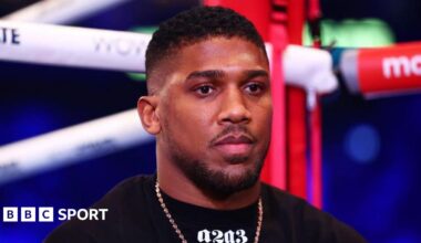 Anthony Joshua looks on from ringside during an interview