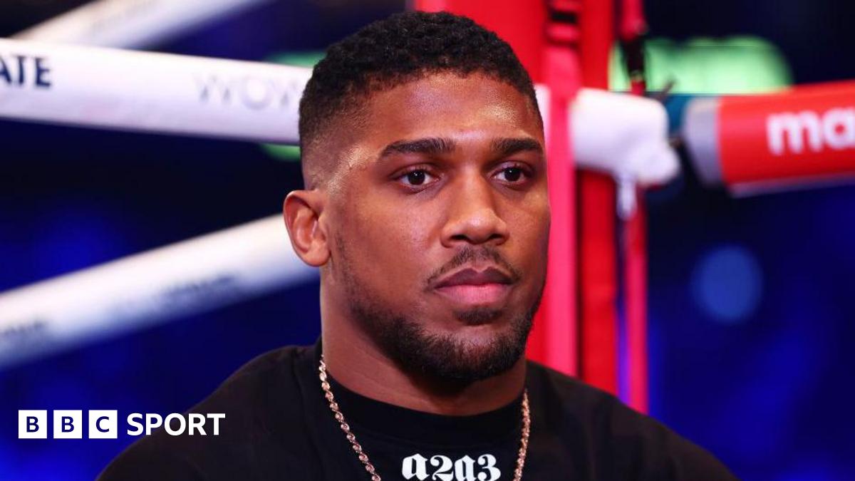 Anthony Joshua looks on from ringside during an interview