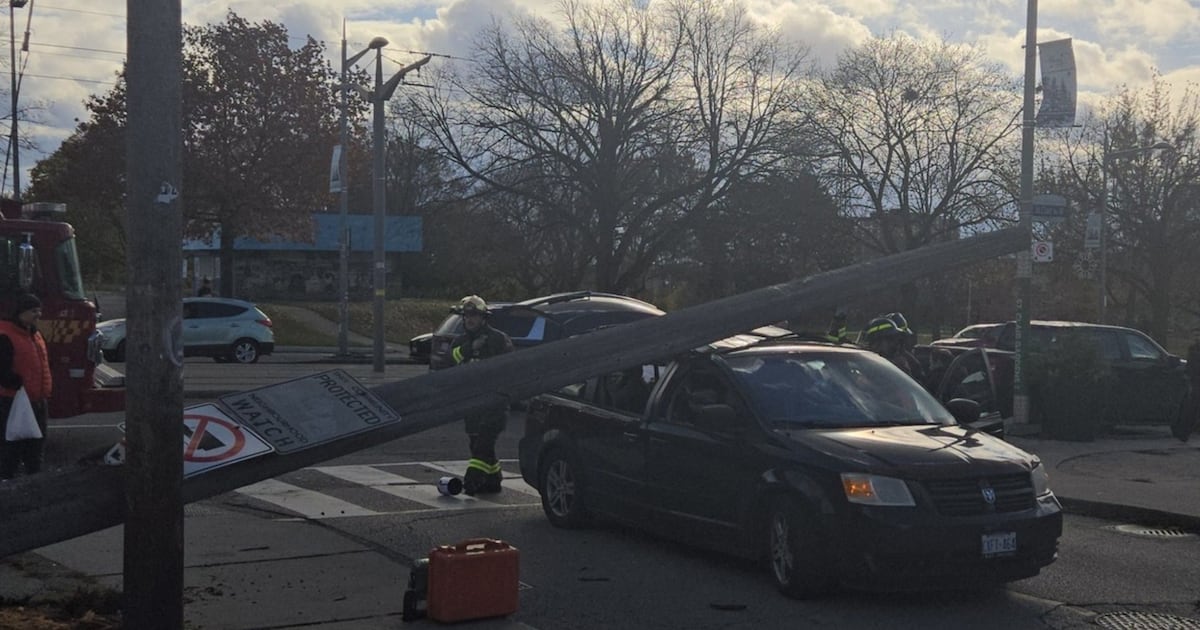 Woman hurt after pole falls on vehicle in Toronto's west end
