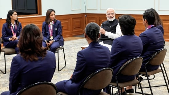 Prime Minister Narendra Modi in conversation with the champions of ICC Women's Cricket World Cup 2025 at his residence in New Delhi on Wednesday.(DPR PMO/ANI Photo)