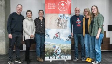 Group of people standing beside Cycling Canada banner.