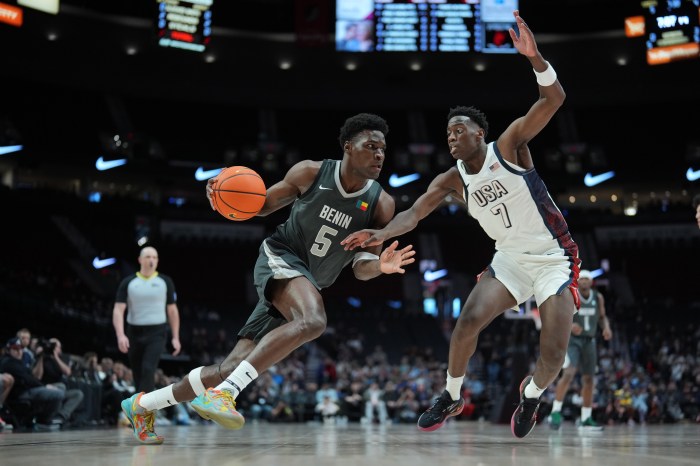 Tounde Yessoufou (left) of Team World dribbles against AJ Dybantsa (right) of Team USA during the 2025 Nike Hoop Summit at Moda Center on April 12 in Portland, Oregon.