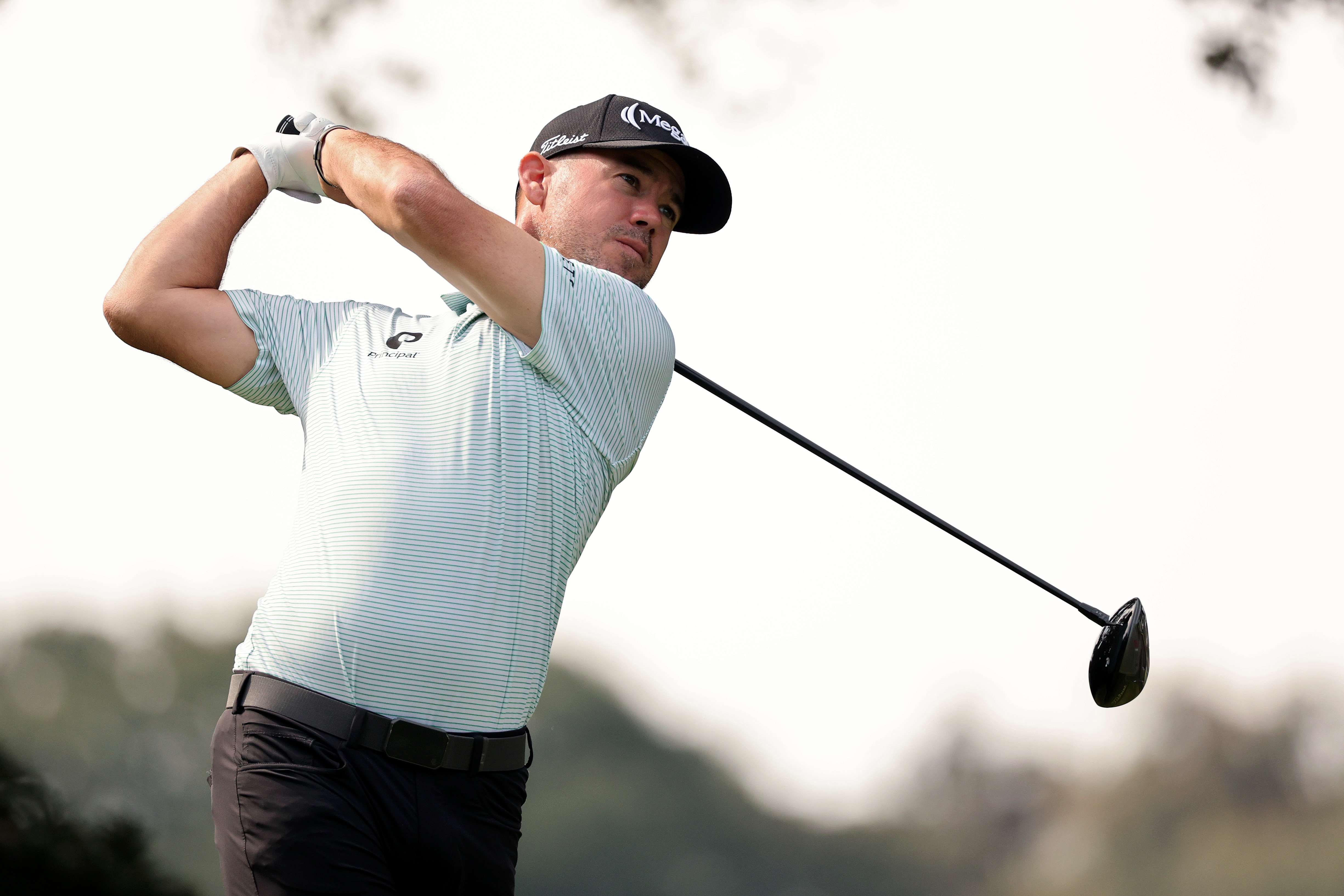 Brian Harman hits a driver and watches its flight