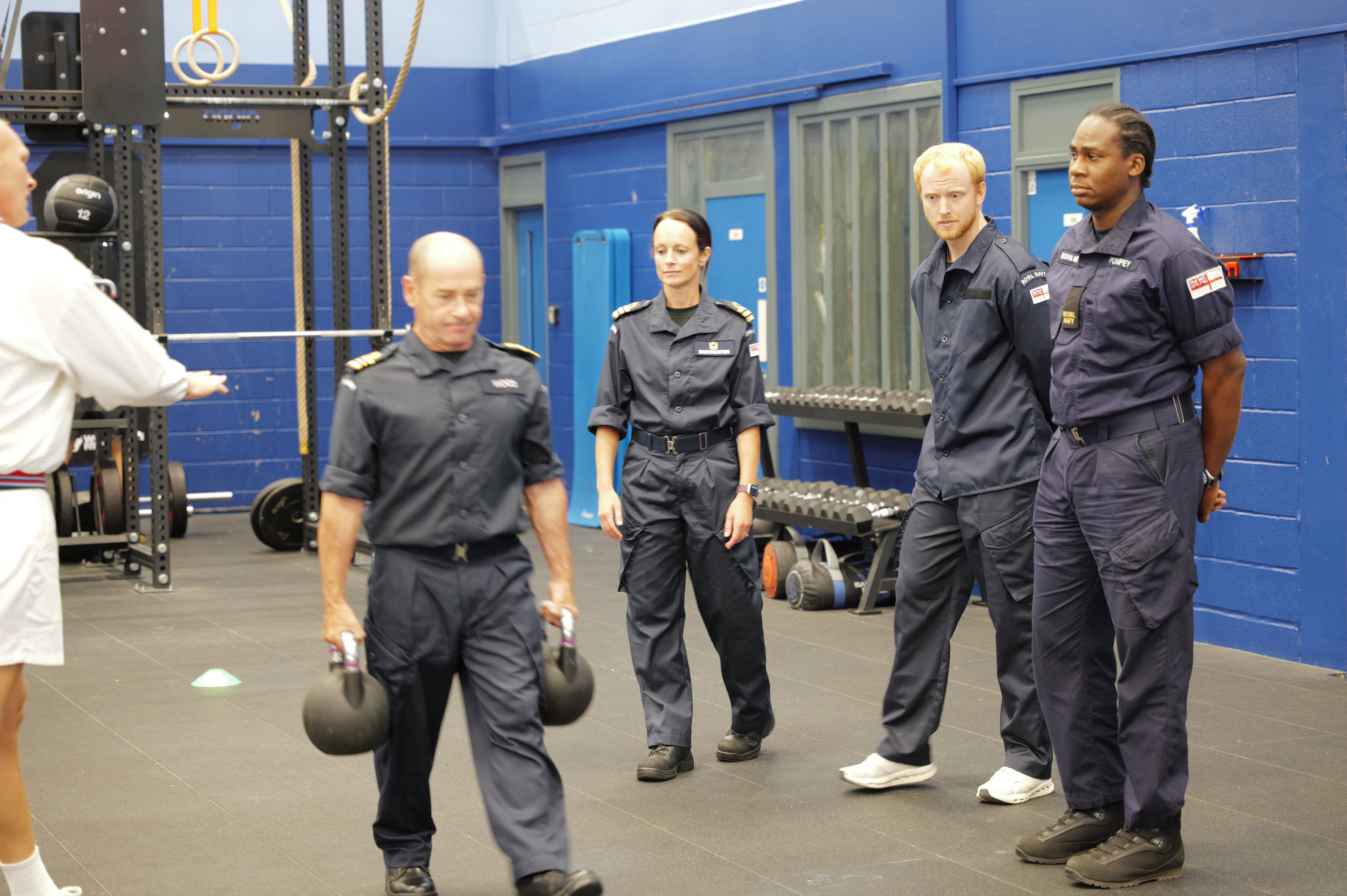 Lieutenant Commander Joseph Wood demonstrates the kettlebell carry