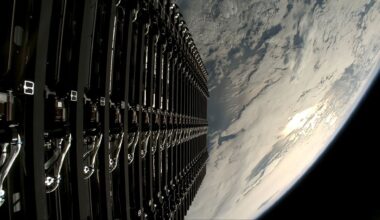 a stacked series of small satellites are seen ready to be deployed into low earth orbit.