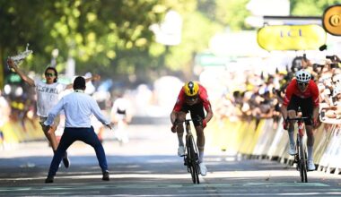 A demonstrator bursts onto the 2025 Tour de France stage 11 finish