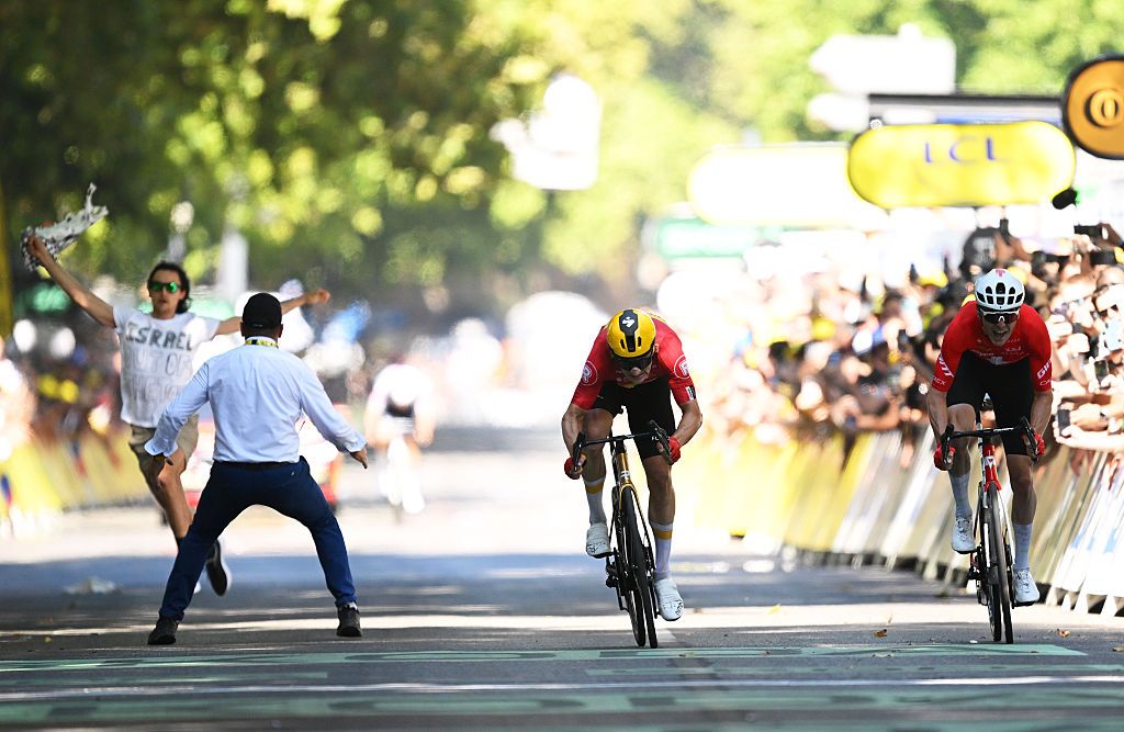 A demonstrator bursts onto the 2025 Tour de France stage 11 finish