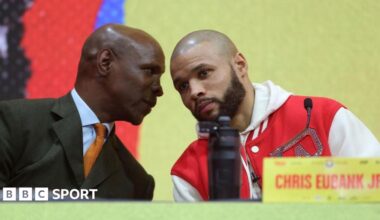 Eddie Hearn holds a card that says 'to me, conor benn is perfect'