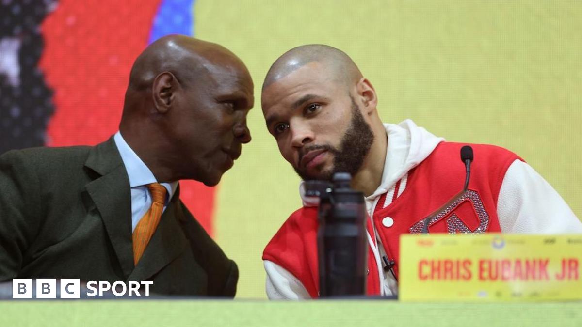 Eddie Hearn holds a card that says 'to me, conor benn is perfect'