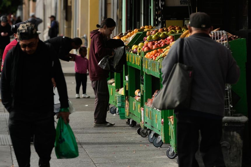 A person shops for produce at a market in San Francisco on November 15, 2025.