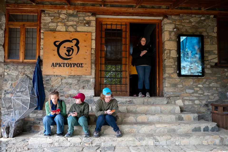 Visitors sit on the stairs inside the Arcturos bear sanctuary in Nymfaio, northern Greece, on Thursday, Oct. 30, 2025. (AP Photo/Giannis Papanikos) (Copyright 2025 The Associated Press. All rights reserved)