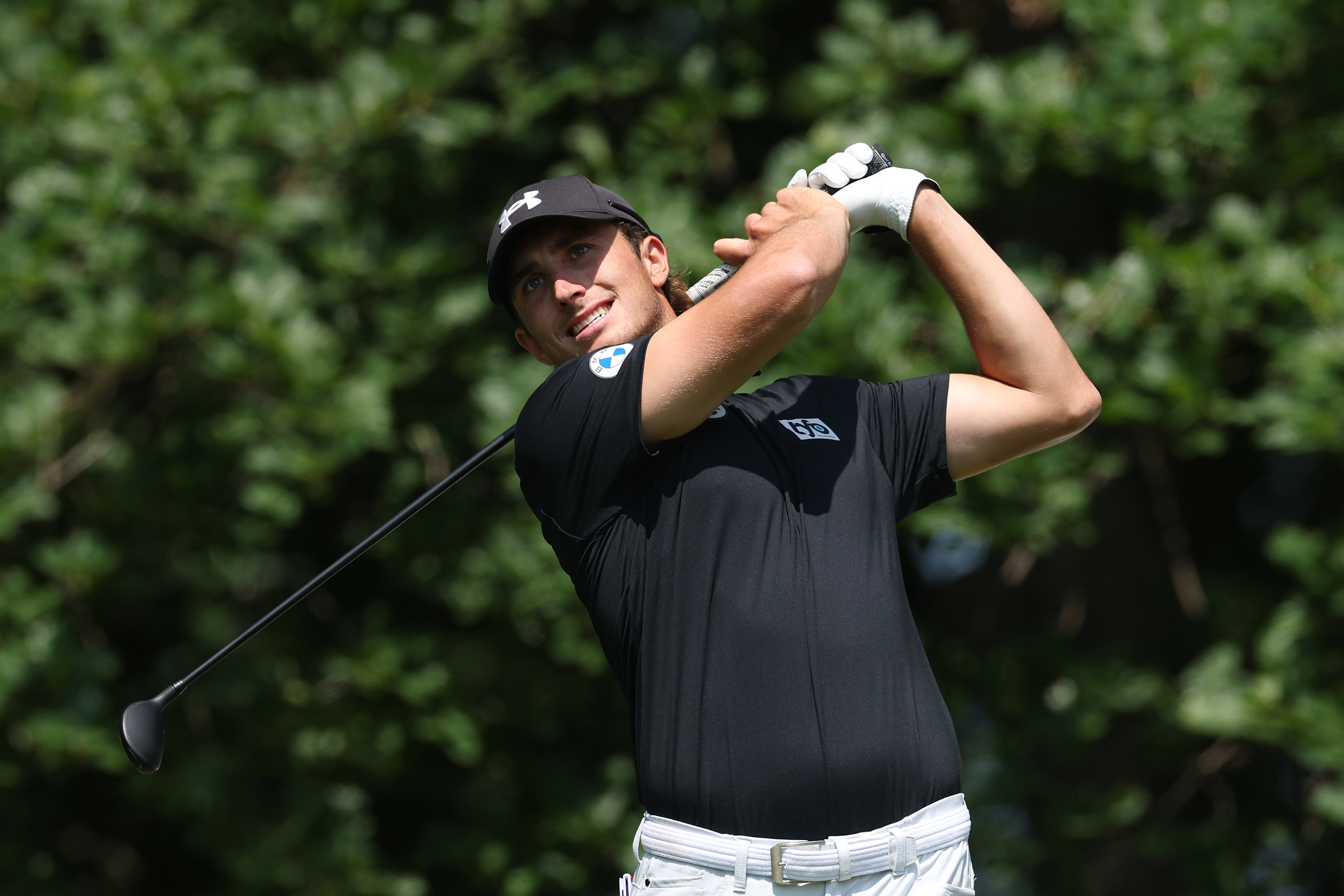 Cedric Gugler hits an iron shot into the green