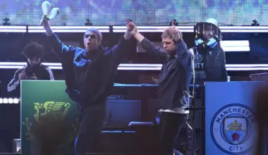 Liam Gallagher (left) and Noel Gallagher of the English rock band Oasis arrive on stage during the first show of their Australian tour at Marvel Stadium, in Melbourne, Australia, on Oct 31.