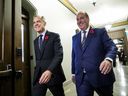Prime Minister Mark Carney walks with MP Chris d'Entremont, who crossed the floor from Conservative caucus to join the Liberals, to a meeting of the Liberal Caucus on Parliament Hill in Ottawa, on Wednesday, Nov. 5, 2025.