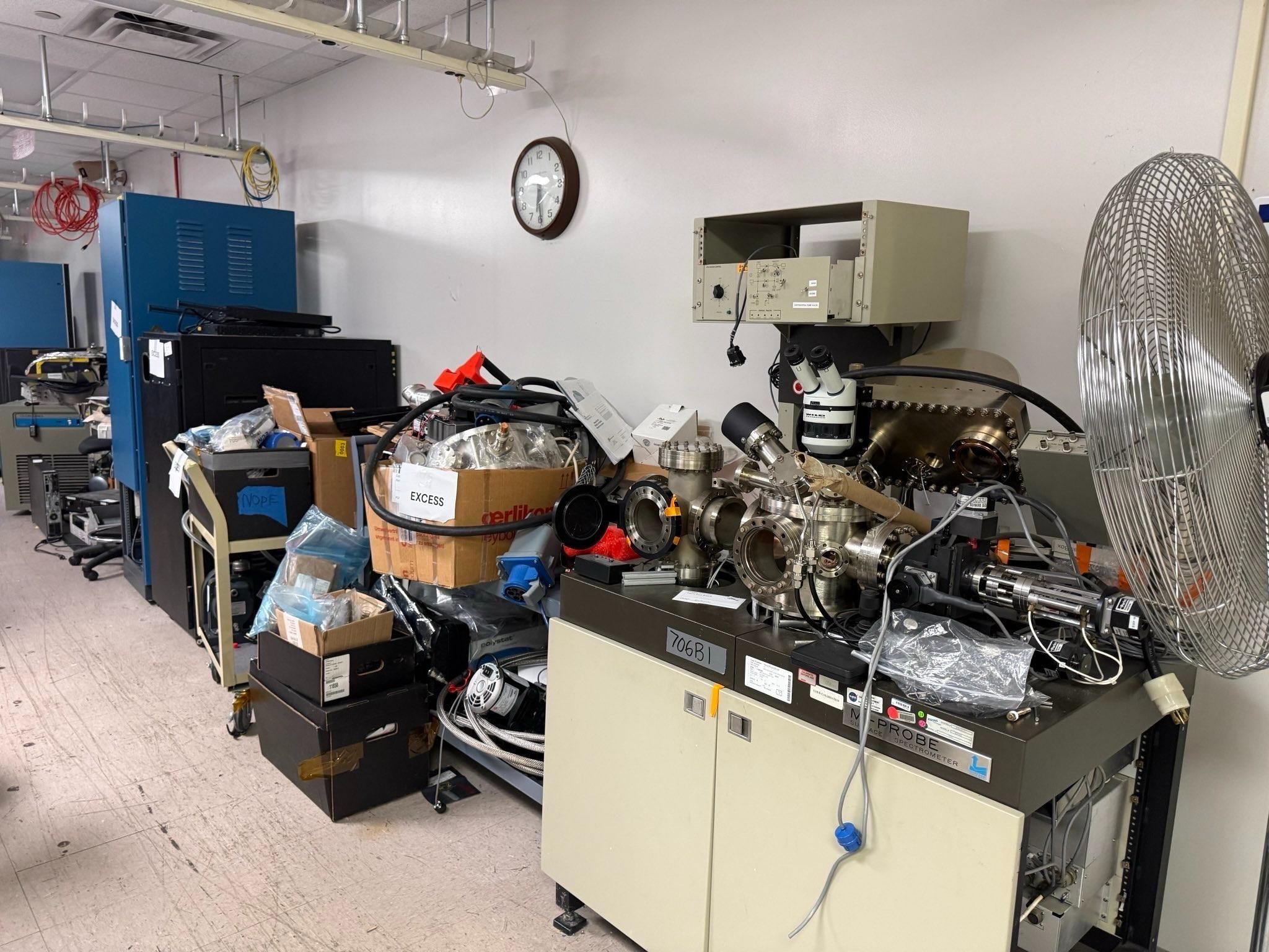 Various office spaces including desks, shelves and warehouses full of items stacked ready to be removed. 