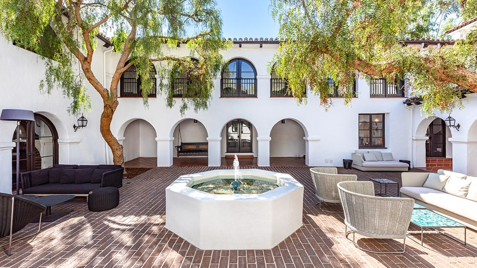 The courtyard in the center of the home features a fountain and multiple seating areas.