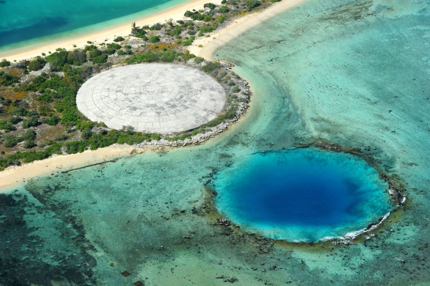 A crater covered by concrete to keep decontaminated soil and another crater both created by nuclear testings are seen in Enewetak Atoll, Marshall Islands, on January 29, 2014.