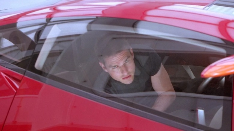 John Anderton in a car looking out a window in Minority Report
