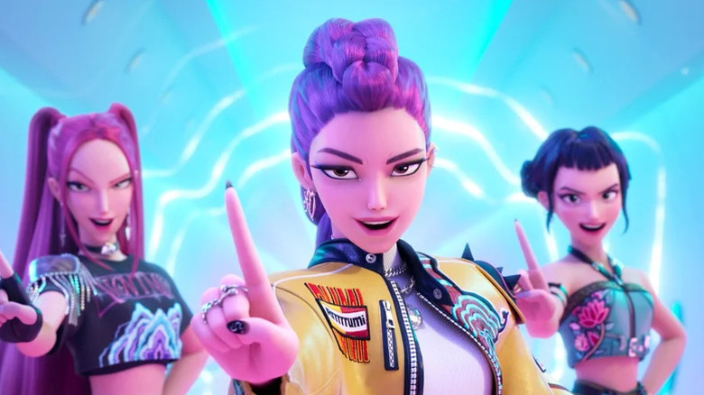 Huntr/x hold up their fingers performing a song in KPop Demon Hunters