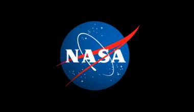 The letters NASA on a blue circle with red and white detail, all surrounded by a black background