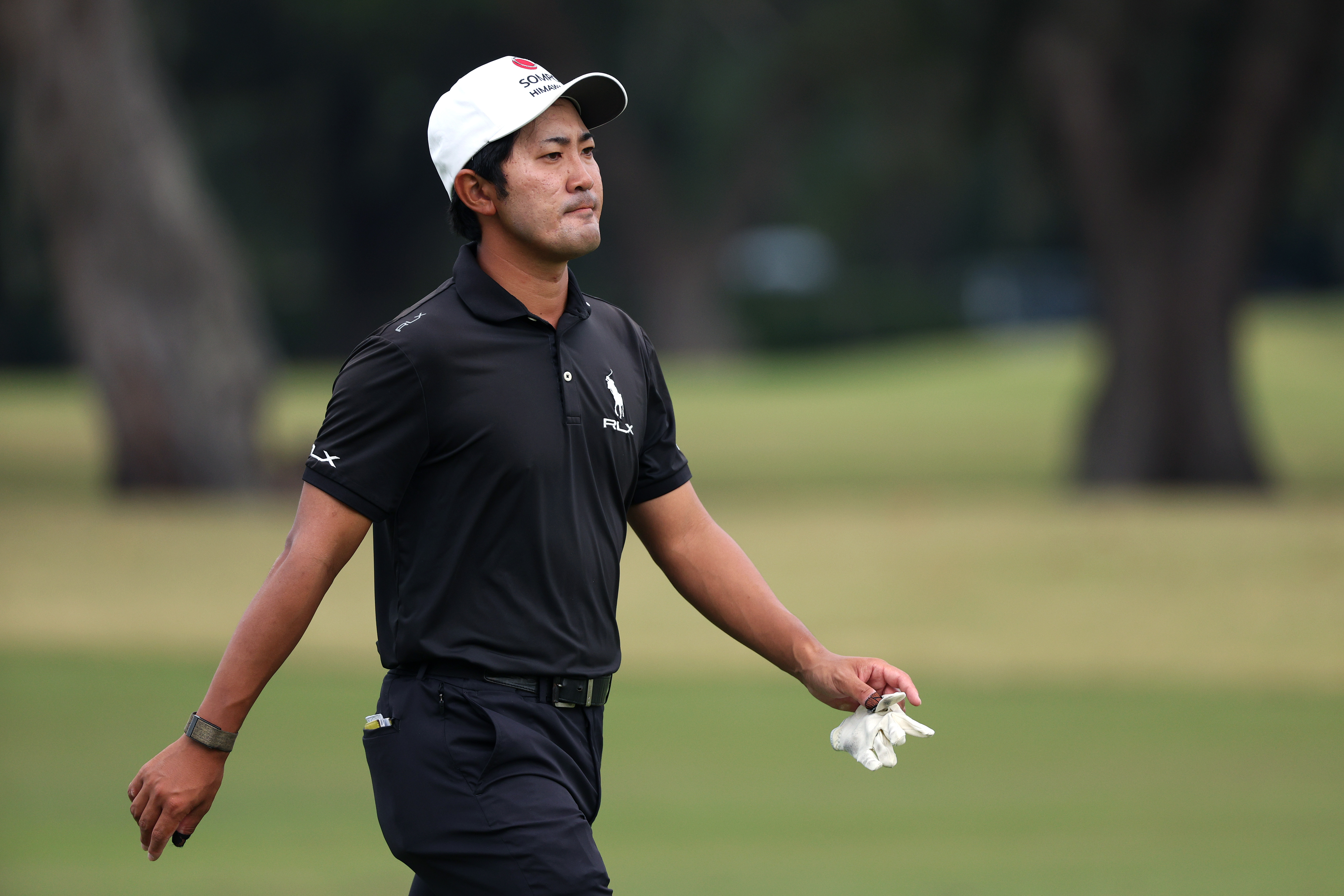 Takumi Kanaya walks down the fairway