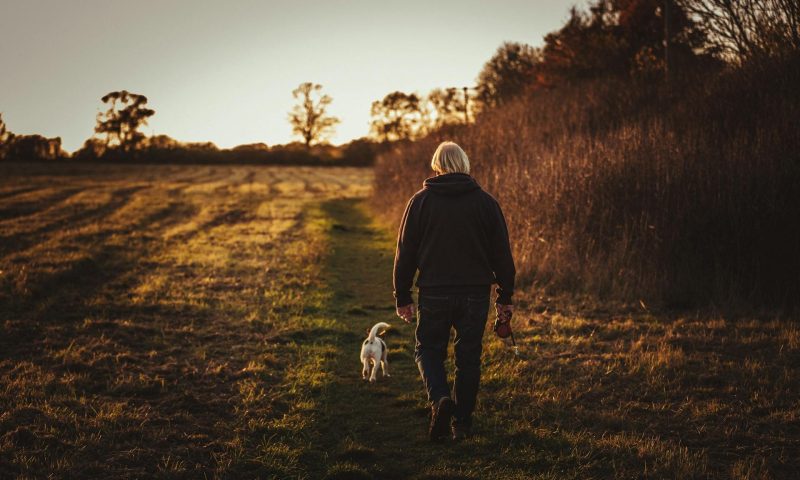 man walking dog outside