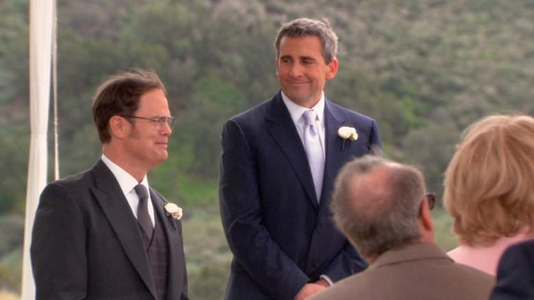 Steve Carell as Michael Scott smiles at Rainn Wilson as Dwight Schrute in the finale of The Office