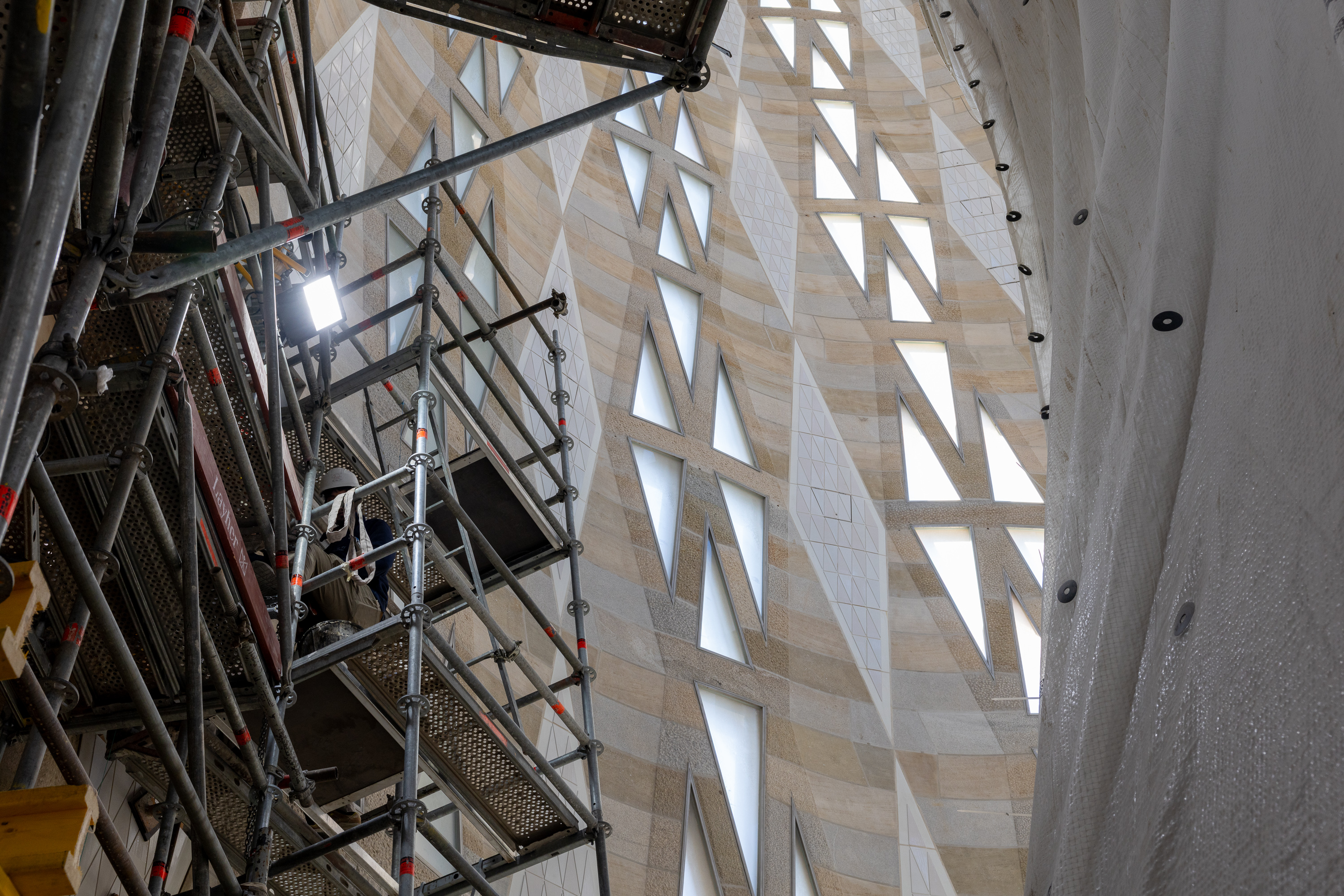Construction worker on scaffolding at the Sagrada Familia basilica.