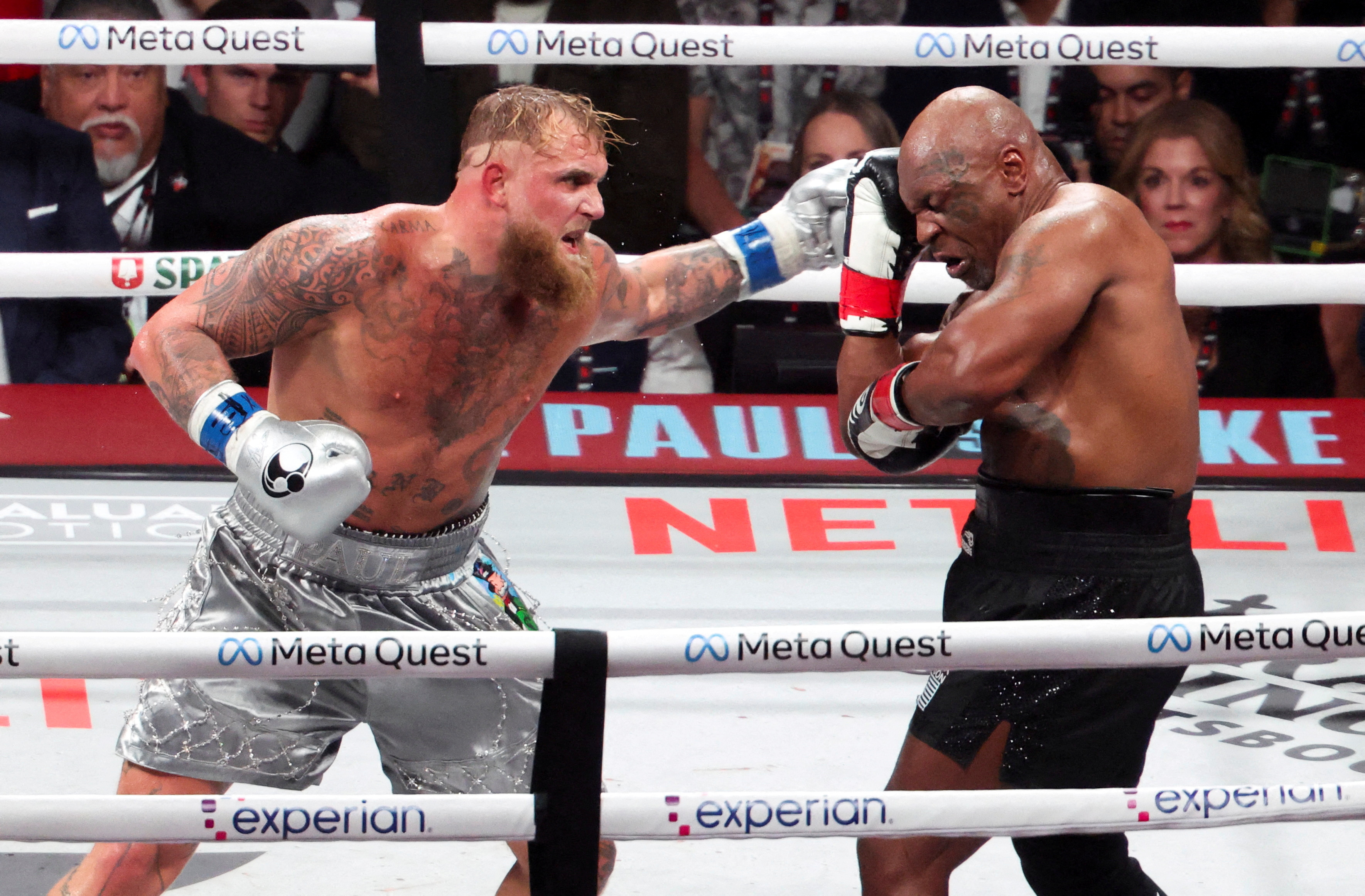 Mike Tyson (black gloves) fighting Jake Paul (silver gloves) at AT&T Stadium.