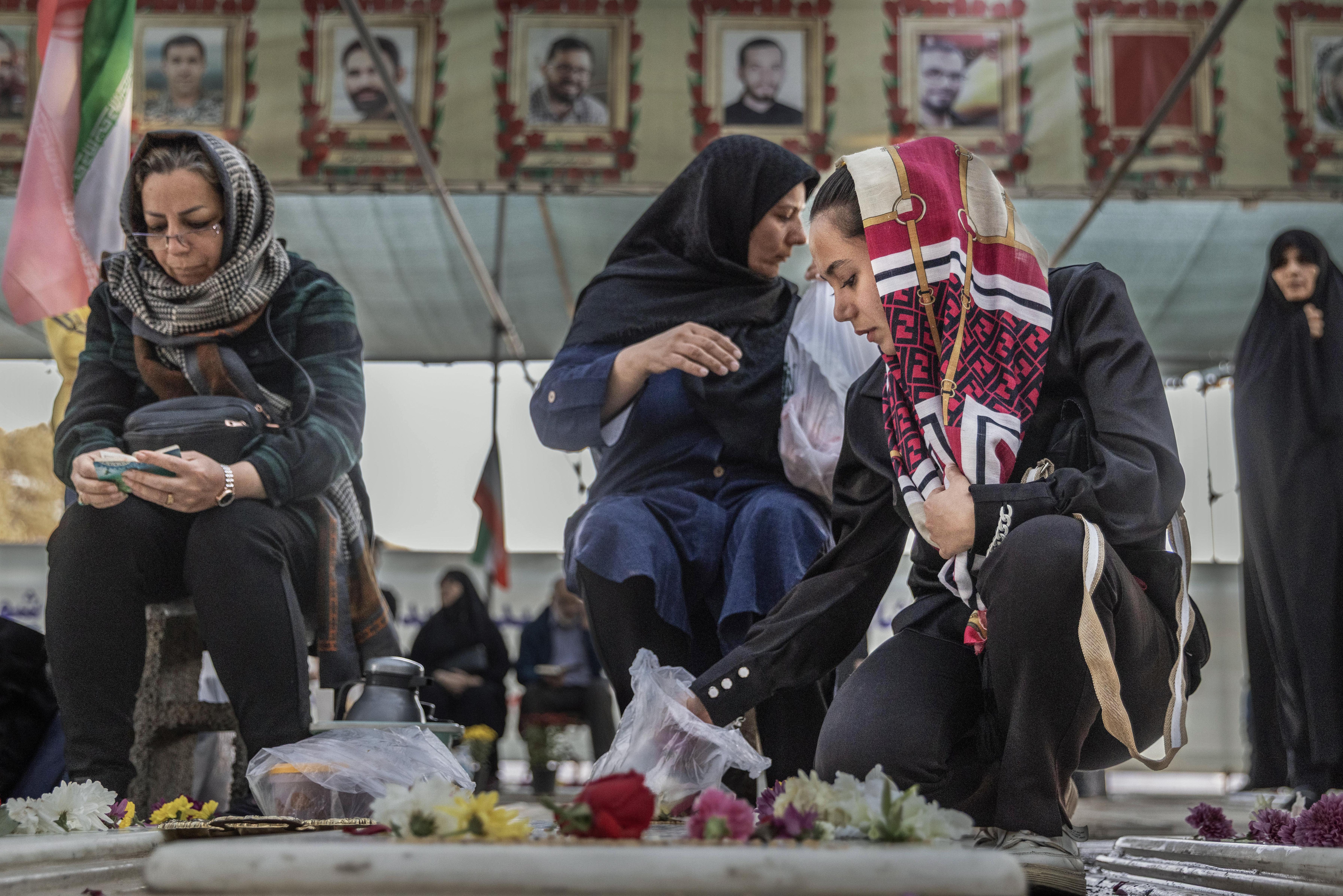 Families visiting the graves of their loved ones in the Martyr’s section of Behesht-e Zahra cemetery in Tehran.
