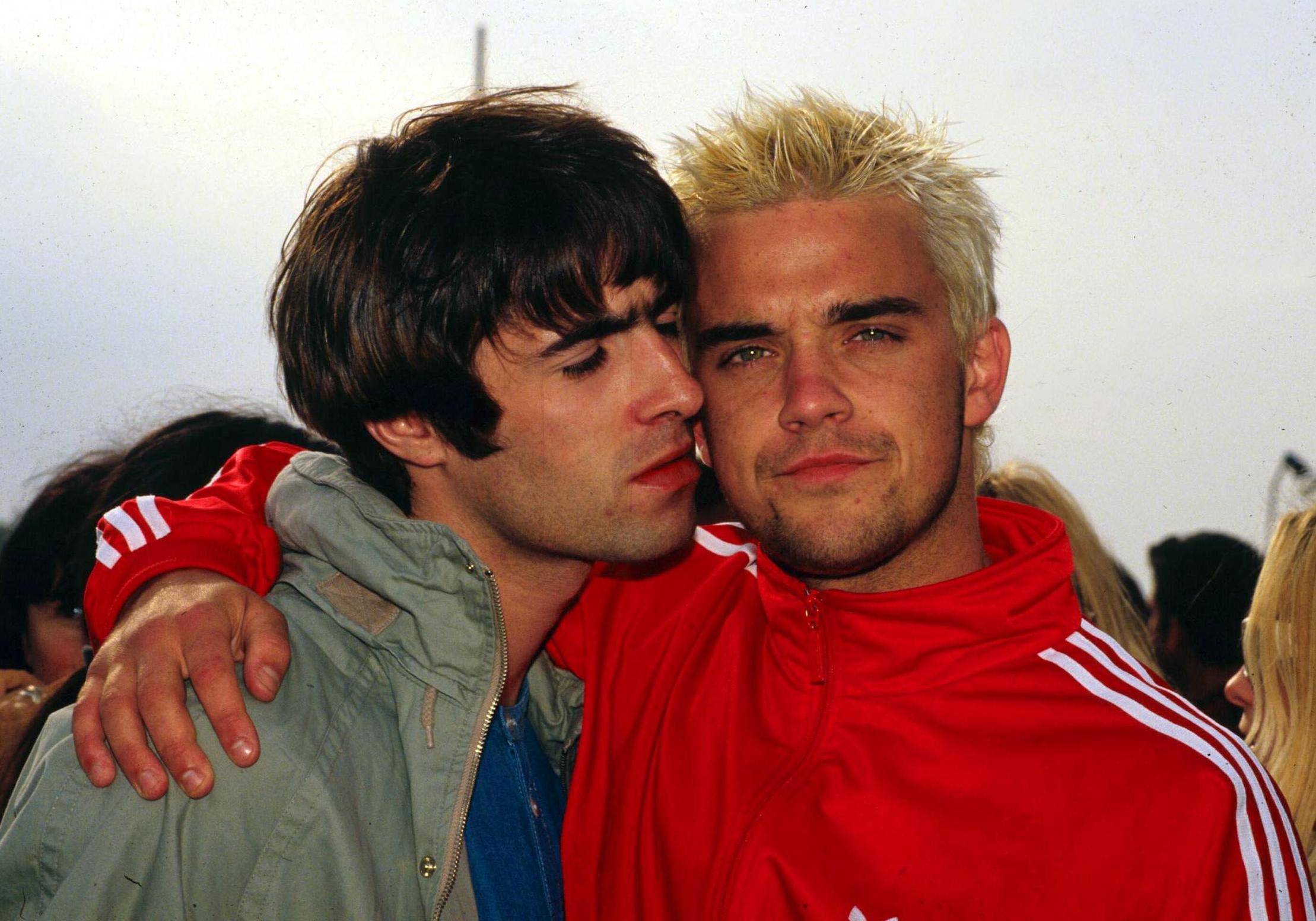 Liam Gallagher and Robbie Williams with arms around each other at Glastonbury Festival 1995.