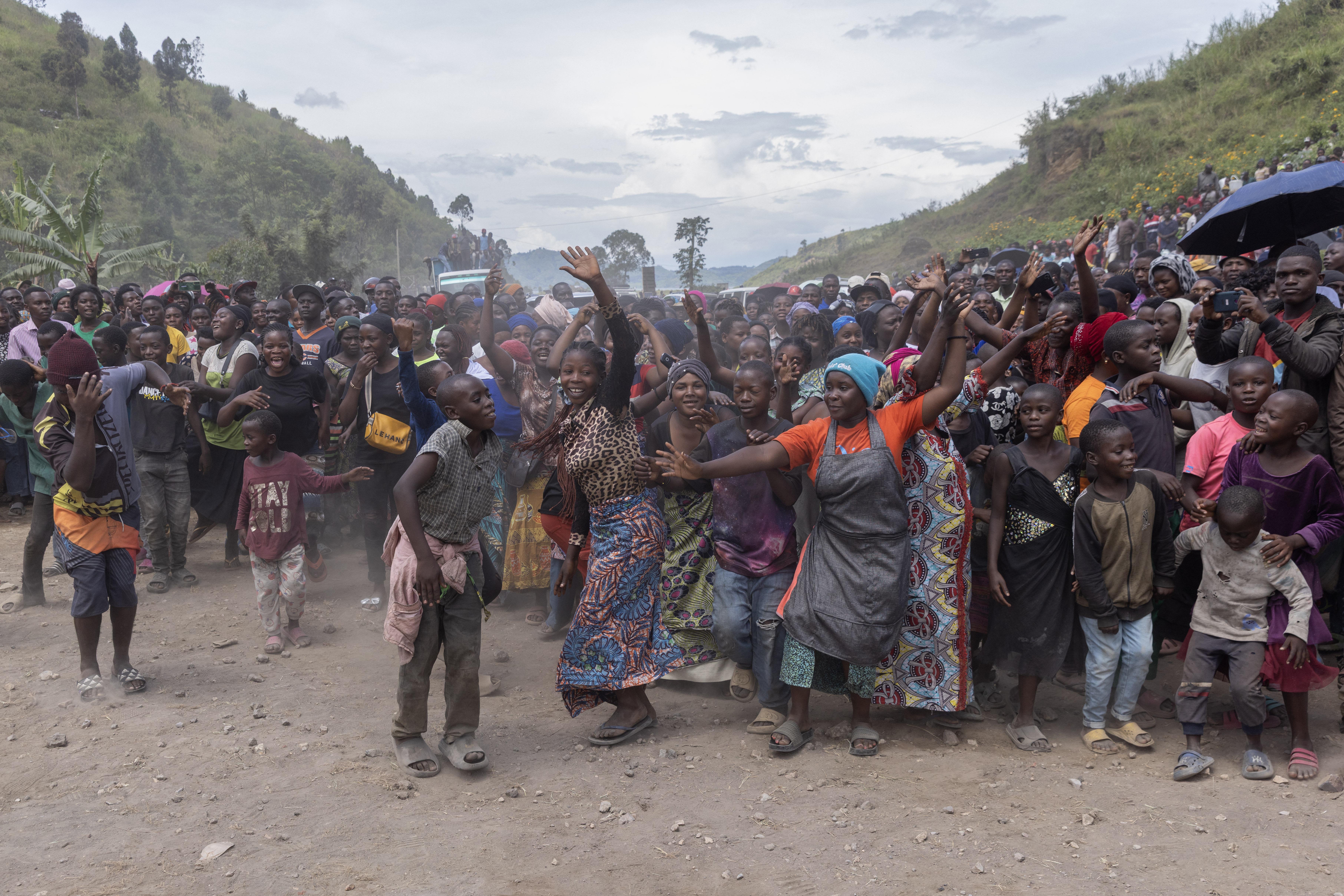 A large crowd, including many children, gathered at an event in Sake to celebrate the unveiling of plans to improve the road to Rubaya.