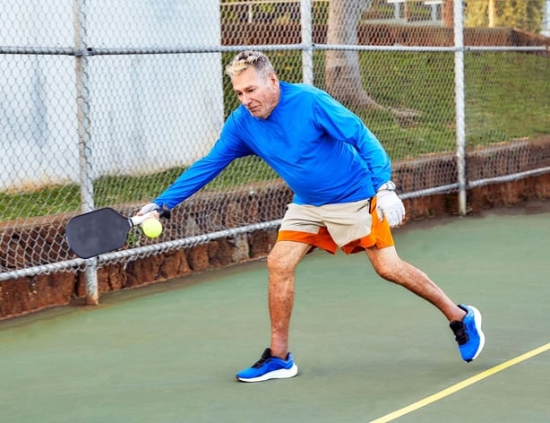 A man playing pickleball