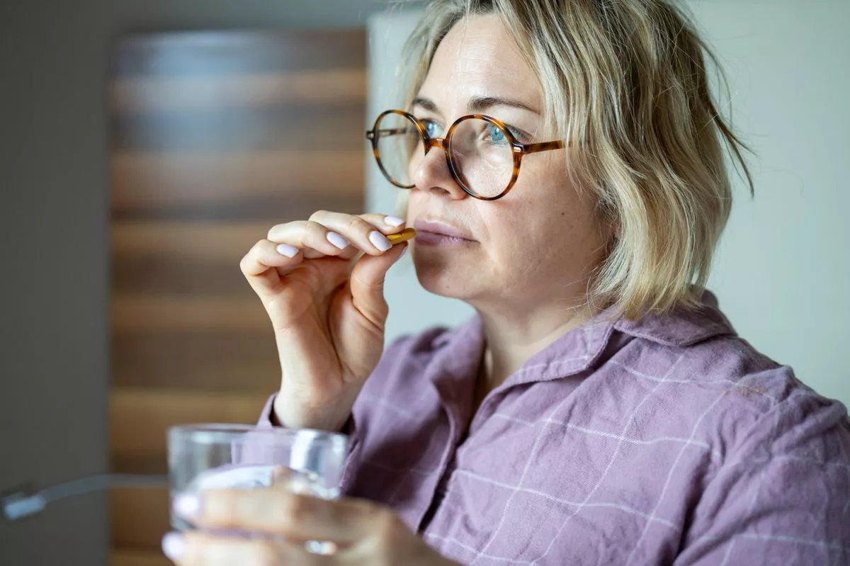 Woman taking supplement
