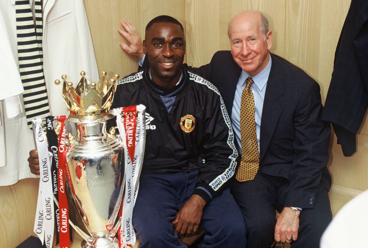 Andy Cole and Sir Bobby Charlton of Manchester United celebrate in the dressing room with the FA Carling Premiership trophy after the match between West Ham United v Manchester United