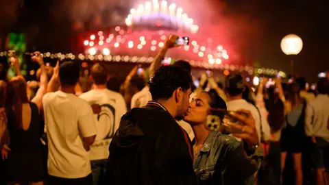 Getty Images Two people kissing during the fireworks in Sydney 
