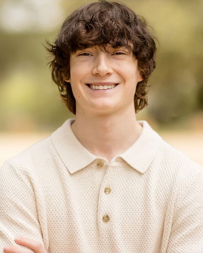 Smiling teenage boy outdoors wearing a cream textured polo shirt, linked to ChatGPT and expert reactions after teen loss news.