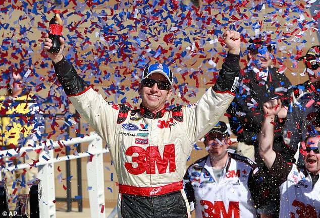 Greg Biffle is seen celebrating a victory after winning the NASCAR Sprint Cup Series at Kansas Speedway in 2010 in Kansas City, Kansas