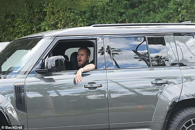 Justin Bieber was seen not bothering to stifle a yawn as he drove his wife Hailey around in his Land Rover Defender in Los Angeles ahead of Christmas