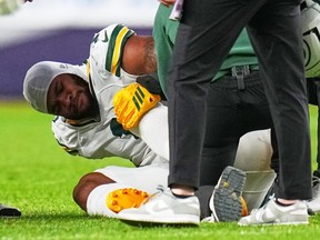 Green Bay Packers' Micah Parsons reacts after a suffering a knee injury against the Denver Broncos.