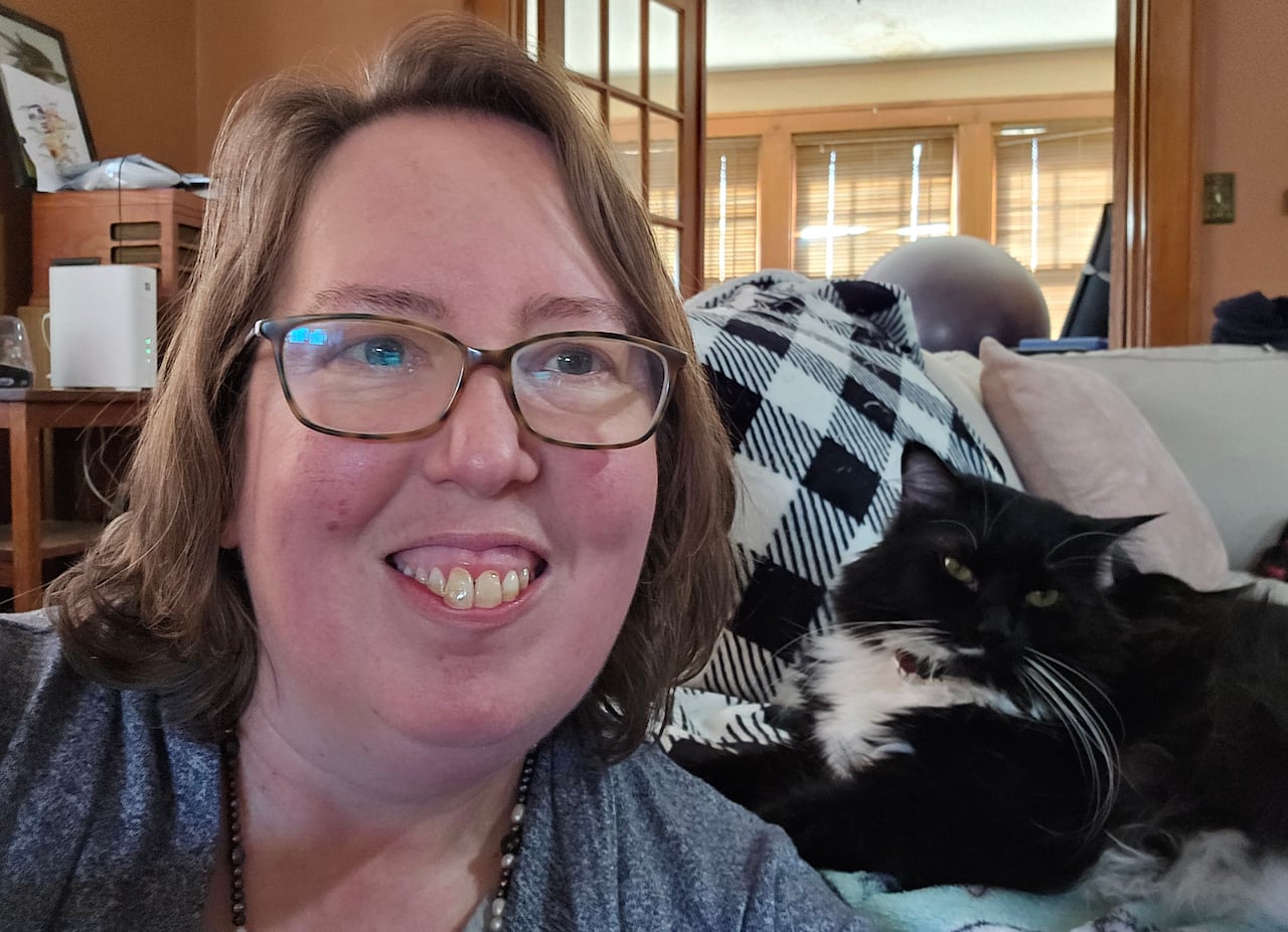 Photo of Lori Hunt at home with her cat. 