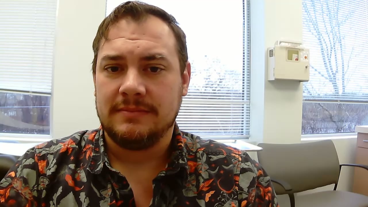 Man seated near a window